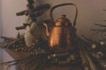 brass kettle and wooden snowman 