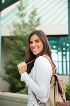 young woman with a book bag 