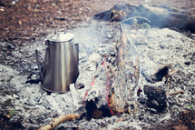 coffee pot in ashes at a campfire site