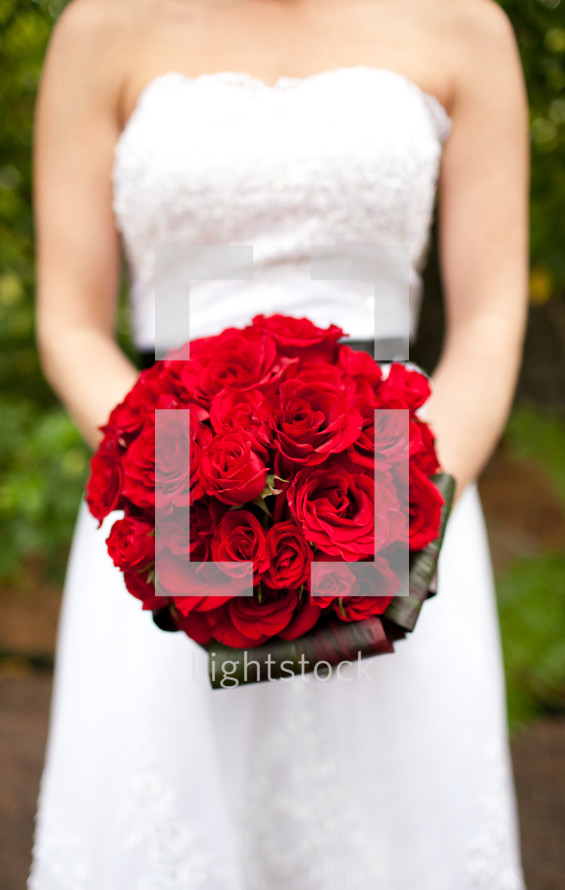 bride holding red roses 