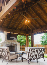 covered patio with fireplace and TV