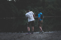 two guys skipping stones 