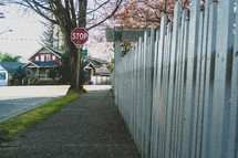 stop sign and white picket fence 