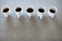 a row of coffee mugs 