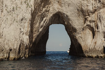 caves through cliffs over the water in Italy 