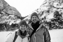 a couple hiking in snow gear 