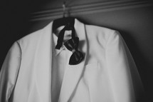 A white tuxedo and black bow tie