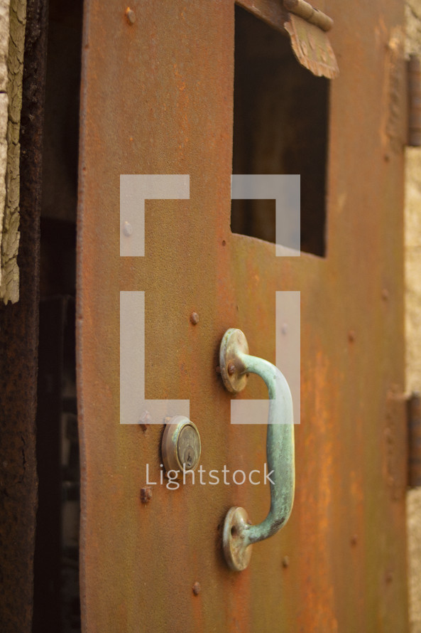 handle on a rusty metal door 