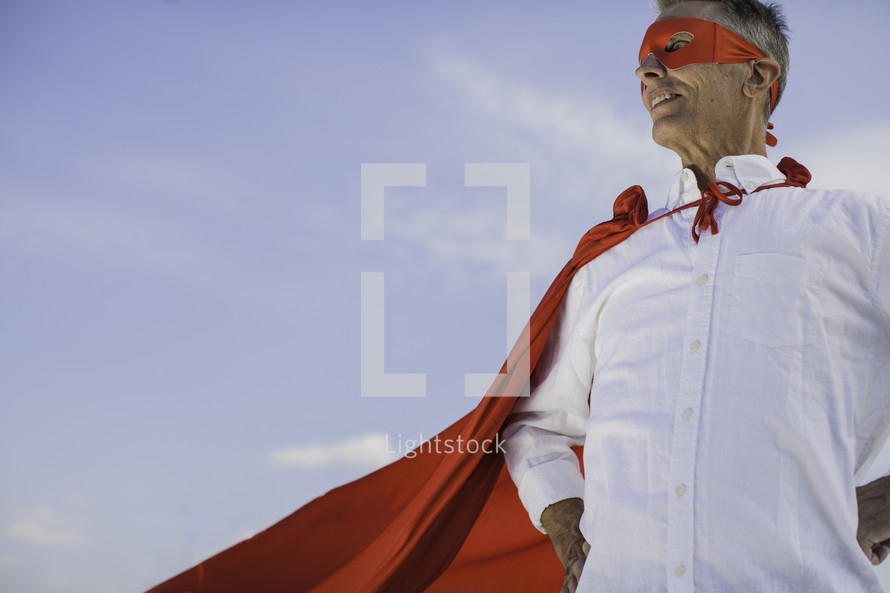a father in a superhero cape 