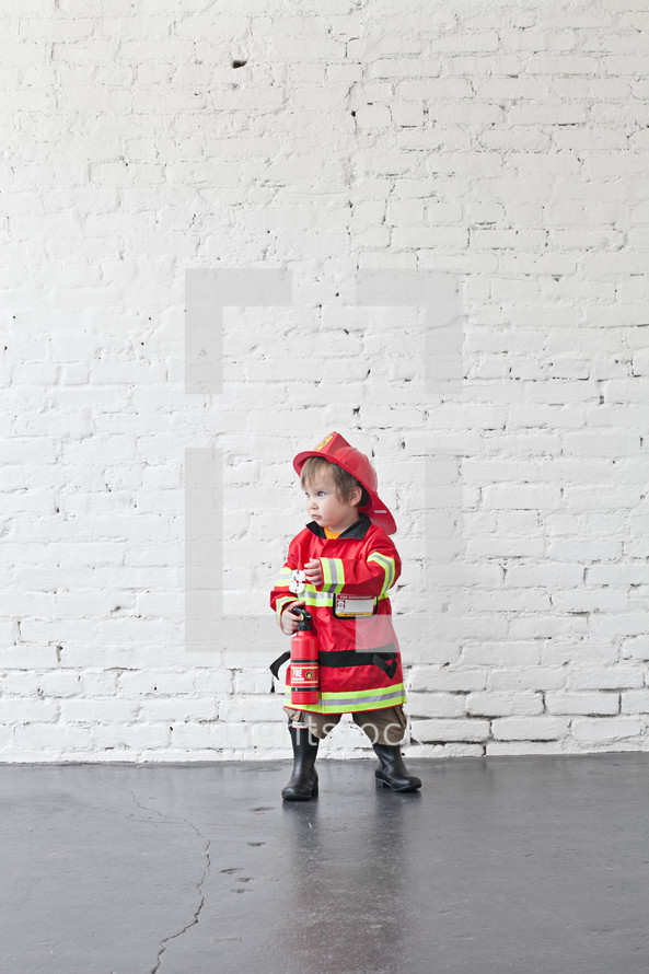 toddler in a fireman costume 