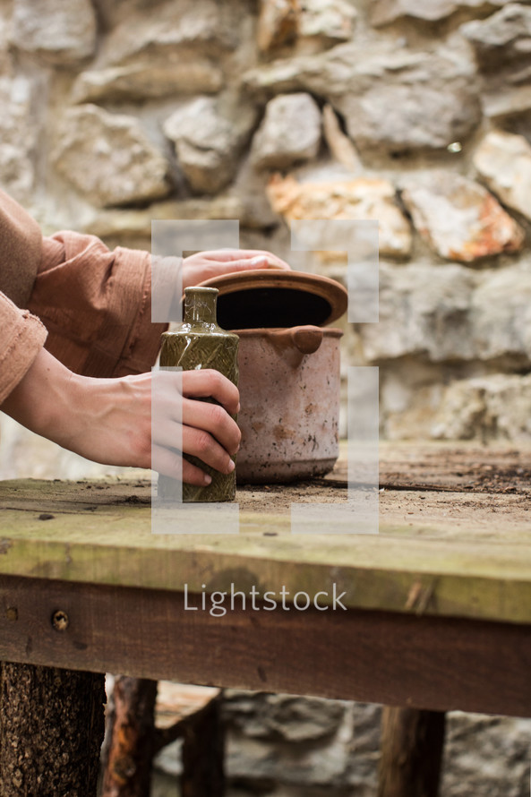 man pouring water into a flask 
