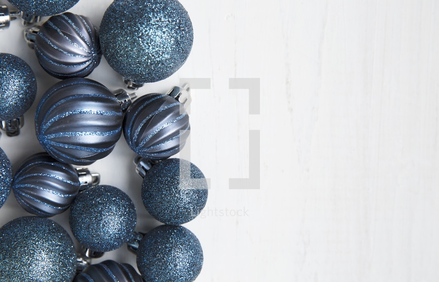 blue Christmas ornaments on a white background 