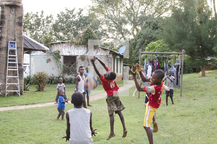 village children playing with a volleyball 
