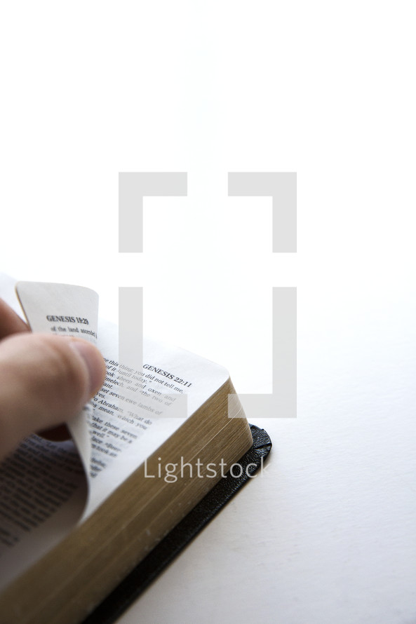hand on a Bible flipping pages