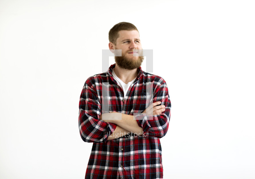 a man in a plaid flannel shirt in studio 