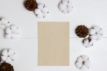 cotton, pine cones, and blank paper 