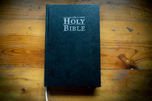 Holy Bible placed on a wooden table in morning. worship prayer and bible study concept.