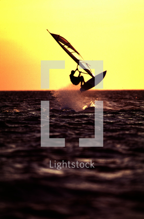 silhouette of a wind surfer at sunset 
