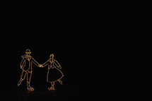Christmas Light display of a man and woman holding hands on ice skates