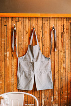 An apron hanging on a hook. 