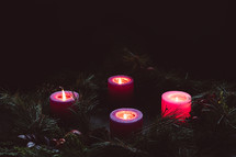 Rustic advent wreath with four candles lit