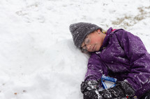 a girl resting in snow 