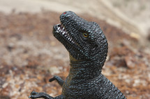 a toy dinosaur looking ferocious