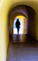 silhouette of a woman in a tunnel 