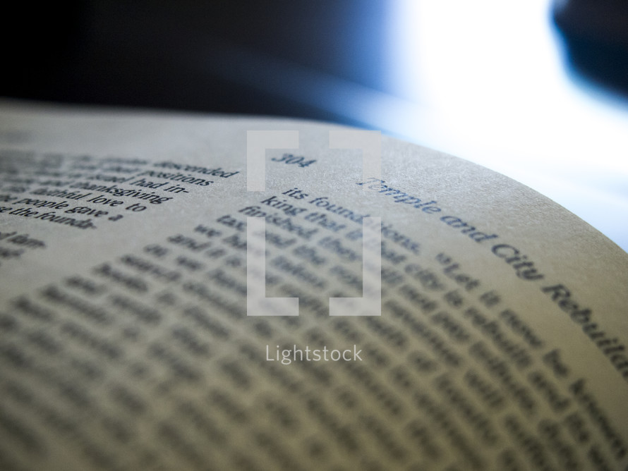 An open Bible with reflected light.