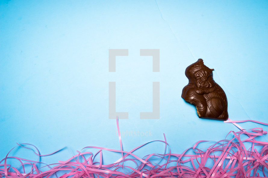 eaten Chocolate Easter rabbit over a blue background 