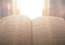 open Bible and sunlight through a window 