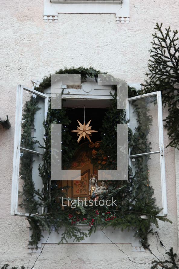 Christmas garland and star decorations in a window 