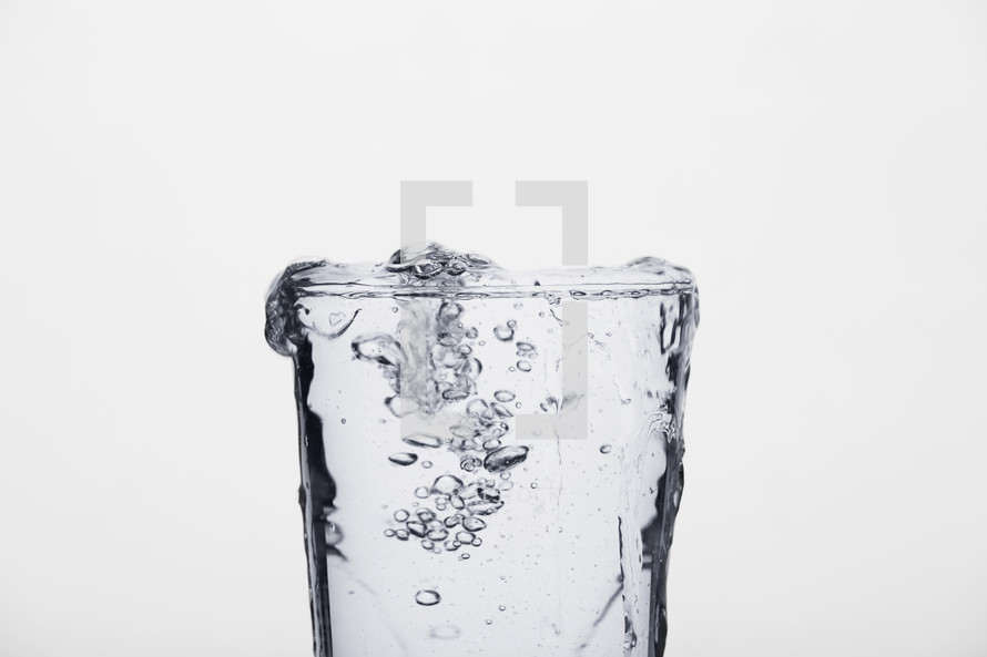 overflowing glass of water.