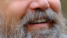 man with a beard smiling 