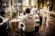 a man playing drums in a church 