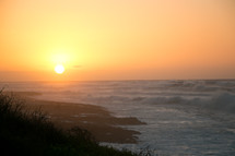 waves along a shore at sunset 