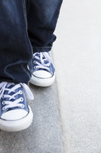 a child walking in sneakers