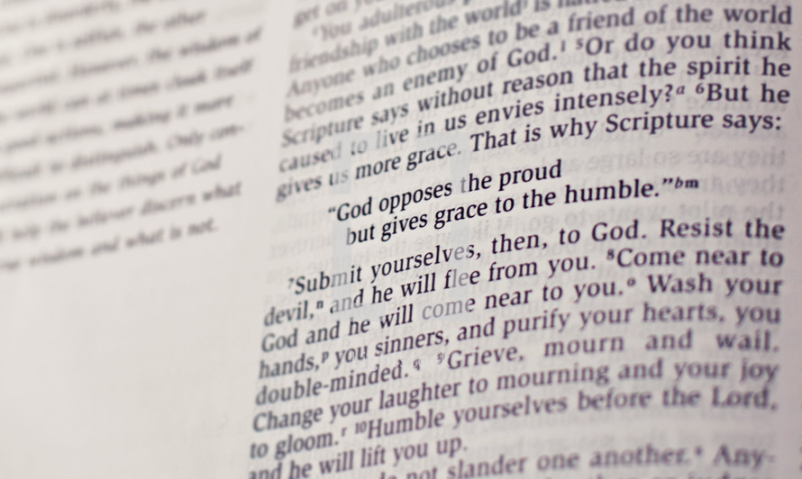 Bible open to James 4:6 -- "God opposes the proud but gives grace to the humble."