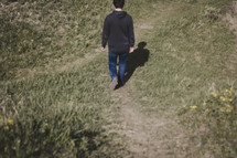 a blurred motion shot of young man walking down a hill