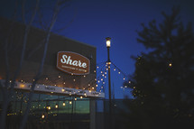 share, everything is better sign at night 