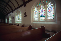 stained glass windows and pews 