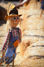 scarecrow and hay bales 