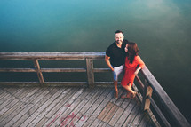 a couple standing on a dock 