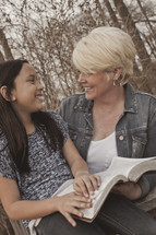 woman and a girl reading a Bible together - mentoring 