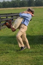 a reunited couple hugging in a pasture