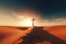 Cross in the desert at sunset