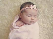 a newborn girl sleeping 
