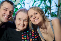 Happy couple posing with grandma