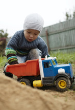 Boy playing with toy truck outdoor