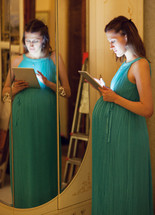 Pregnant woman using tablet at home